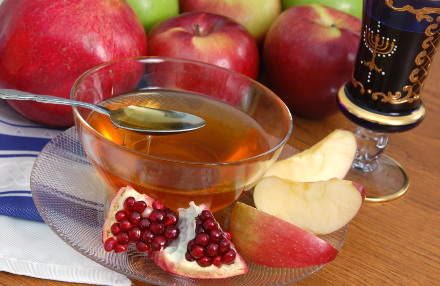 Photo of honey, apples, pomegranate.